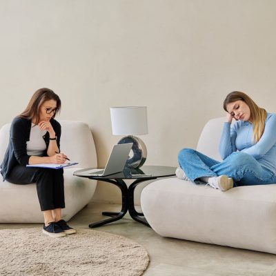 young-woman-in-mental-therapy-talking-with-profess-V5YV5X6.jpg